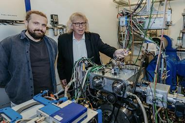 Researchers Aristidis Dafis (left) and Hermann Rottengruber pose with the single-cylinder experimental engine. The efficiency of fuel to mechanical work is claimed to be 60%, a full 10% higher than an equivalent diesel.