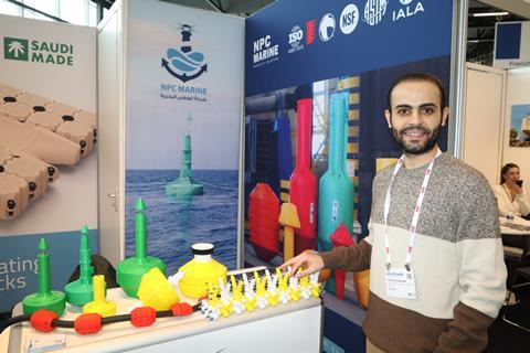 CEO of NPC Marine Faris Al-Hubayyeb with a model of the floating barrier. The structure’s colours, length and range of attachments are all fully customisable depending on the application. Models of other products can also be seen.