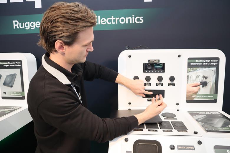 Ryan Pickren demonstrates the retractable USB cable system, which offers 100W at 12VDC thanks to advanced electronics. This allows larger devices such as laptops and tablets to be charged on board
